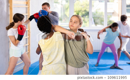 Boy and girl practicing self-defense techniques 109611995