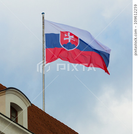 National flag of slovakia waving against blue sky at roof National flag of slovakia waving against blue sky at roof 109612259