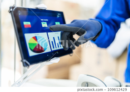 Worker checking the system on a tablet, faceless Worker checking the system on a tablet, faceless 109612429