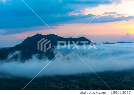Beautiful dramatic sunset in the mountains. Landscape lot of fog Phu Thok Mountain at Chiang Khan ,Loei Province in Thailand. Beautiful dramatic sunset in the mountains. Landscape lot of fog Phu Thok Mountain at Chiang Khan ,Loei Province in Thailand. 109613077