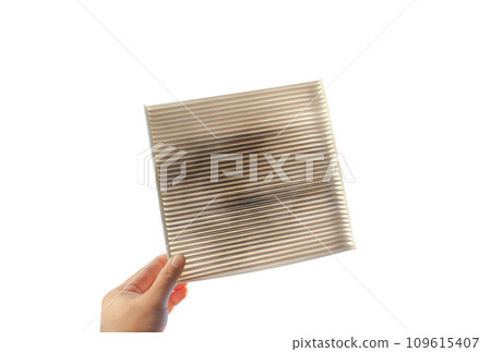 Car air conditioner filter isolated , filter clogged and dirty in a hand on white background Car air conditioner filter isolated , filter clogged and dirty in a hand on white background 109615407