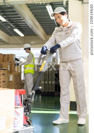 Warehouse manager moving pallets with jack Warehouse manager moving pallets with jack 109616680
