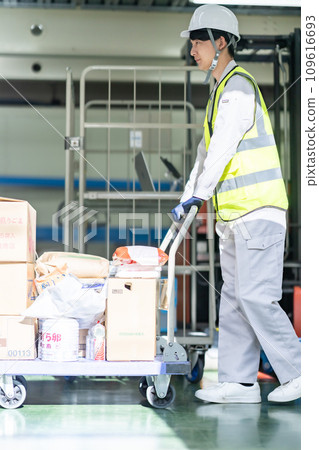 Warehouse manager wearing a safety reflective vest Warehouse manager wearing a safety reflective vest 109616693