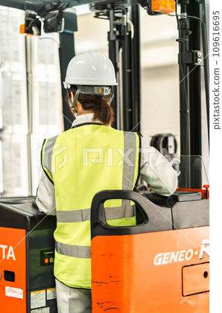 Back of a female worker in her 20s driving a forklift 109616695