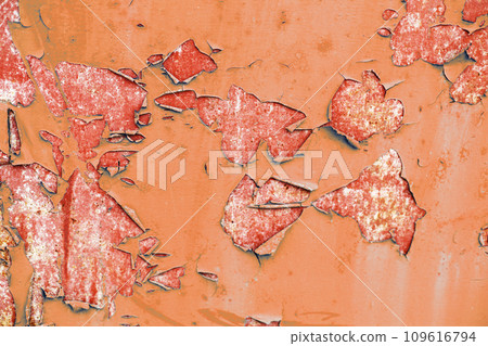 Old Peach Fuzz paint peeling from red concrete wall texture background. Old Peach Fuzz paint peeling from red concrete wall texture background. 109616794