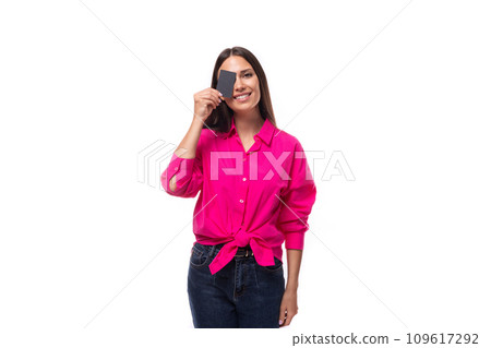 young cute caucasian brunette woman in pink shirt holding plastic card mockup young cute caucasian brunette woman in pink shirt holding plastic card mockup 109617292