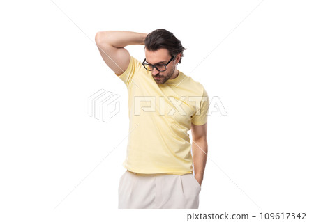 fashionable young successful European guy with stubble and mustache dressed in a light yellow T fashionable young successful European guy with stubble and mustache dressed in a light yellow T 109617342