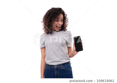 portrait of a young surprised joyful 30 year old caucasian woman in a gray t-shirt holding a 109618062