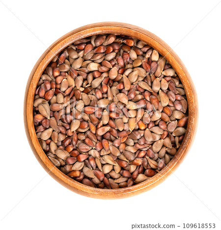 Dried apple seeds in a wooden bowl. Brown seeds of apples from the genus Malus. Should not be eaten because of containing amygdalin and cyanide. Used as apple seed oil in cosmetics or for germination. Dried apple seeds in a wooden bowl. Brown seeds of apples from the genus Malus. Should not be eaten because of containing amygdalin and cyanide. Used as apple seed oil in cosmetics or for germination. 109618553