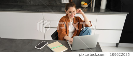 Top view of young student, woman in glasses, sitting at home with laptop, studying, doing homework or joining online course lesson from computer 109622025
