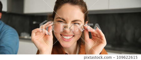 Close up portrait of attractive smiling woman with glasses, laughing and looking happy at camera Close up portrait of attractive smiling woman with glasses, laughing and looking happy at camera 109622615
