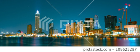 Rotterdam Business District at Night: Glowing Skyscrapers and City Lights Illuminating the Sky 109623287