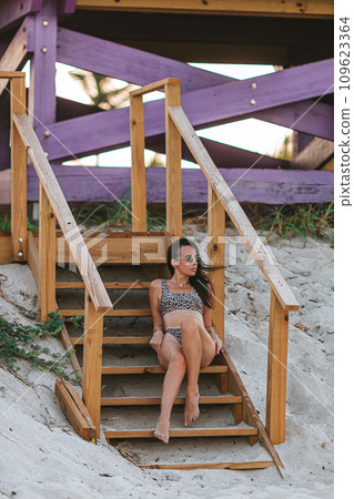 Young happy woman on the beach enjoy her summer vacation 109623364