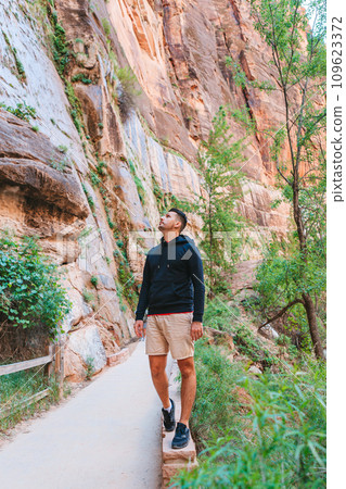 Zion National Park with different trail on the way. Young man walking in park Zion National Park with different trail on the way. Young man walking in park 109623372
