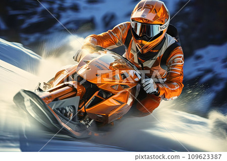 Race driver with helmet speeding on a snowmobile down a steep slope, kicking up snow to the sides 109623387