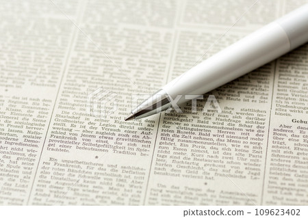 Foreign language newspaper and pen Foreign language newspaper and pen 109623402
