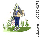 Girl standing on greenery with a box 109624278
