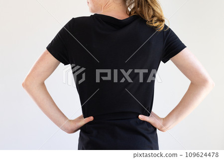 Rear view of caucasian woman in black t-shirt and copy space on white background 109624478