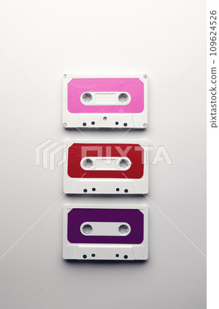 Overhead view of three colourful cassette tapes arranged on white background Overhead view of three colourful cassette tapes arranged on white background 109624526