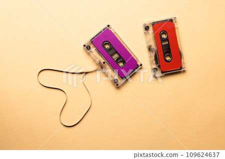 Overhead view of two colourful cassette tapes on beige background Overhead view of two colourful cassette tapes on beige background 109624637