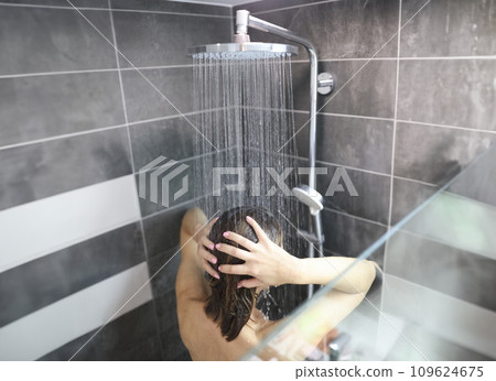 woman takes cool shower and washes hair woman takes cool shower and washes hair 109624675