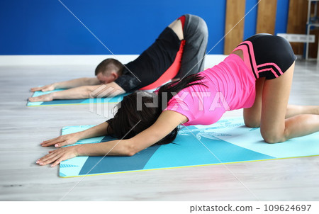 Man and woman do exercises for spine in gym 109624697