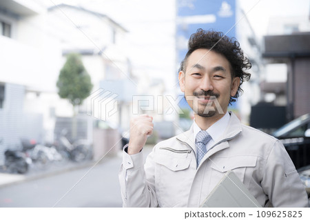 A fist pump of a man wearing work clothes A fist pump of a man wearing work clothes 109625825