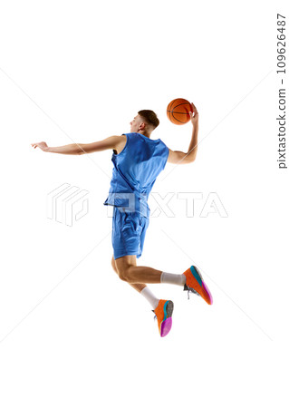 Slum dunk. Full-length image of young guy, basketball player in motion, jumping with ball isolated over white background. Sport concept Slum dunk. Full-length image of young guy, basketball player in motion, jumping with ball isolated over white background. Sport concept 109626487