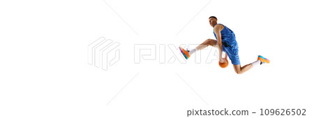 Dynamic image of young man, basketball player in motion, jumping with ball isolated over white background. Sport concept 109626502