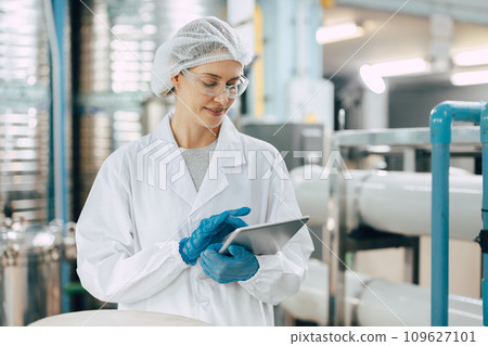 Happy senior science staff women worker work control quality of water in drinking water plant using tablet to record jobs. Happy senior science staff women worker work control quality of water in drinking water plant using tablet to record jobs. 109627101