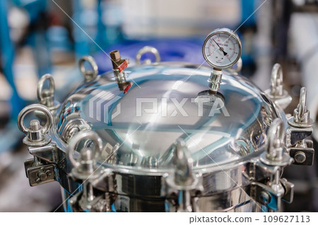 Closeup Pressure Tank Cap Locked. Stainless Steel Sanitary Round Tank Manway Manhole Door Cover Lock With Pressure Gauge In Industry Factory. 109627113