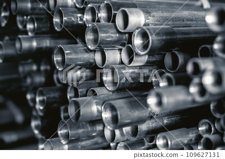 Metal pipes connector tubes. Construction cylindrical steel pipe stacked valious size in construction equipment store shelf. Metal pipes connector tubes. Construction cylindrical steel pipe stacked valious size in construction equipment store shelf. 109627131