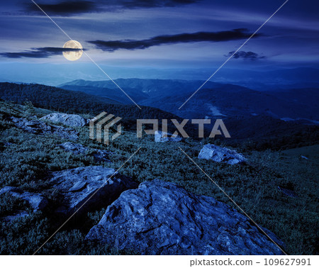 mountainous landscape at night. stones on the hillside. wonderful nature scenery in full moon light 109627991