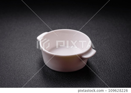 Beautiful empty white ceramic gravy boat on a textured concrete background Beautiful empty white ceramic gravy boat on a textured concrete background 109628226