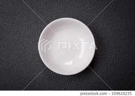 Beautiful empty white ceramic gravy boat on a textured concrete background 109628235