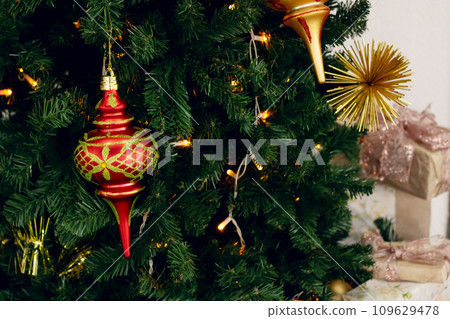 New Year's decorations on green spruce branches New Year's decorations on green spruce branches 109629478