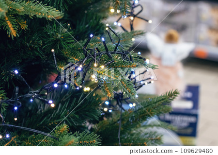 New Year's decorations on green spruce branches New Year's decorations on green spruce branches 109629480