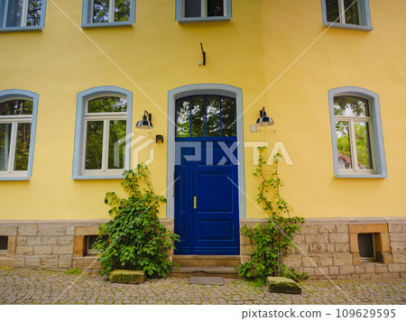 spring trip to Europe. Travel and German sightseeing locations. scenic view to facade of old historic houses somewhere in Erfurt city, details of ancient medieval houses, windows and doors 109629595