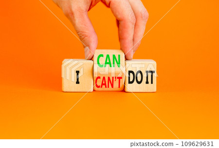 I can do it symbol. Concept word I can or can not do it on beautiful wooden cubes. Beautiful orange table orange background. Businessman hand. Business and i can or not do it concept. Copy space. I can do it symbol. Concept word I can or can not do it on beautiful wooden cubes. Beautiful orange table orange background. Businessman hand. Business and i can or not do it concept. Copy space. 109629631