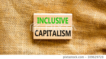 Inclusive capitalism symbol. Concept words Inclusive capitalism on beautiful wooden blocks. Beautiful canvas table canvas background. Business inclusive capitalism concept. Copy space 109629728
