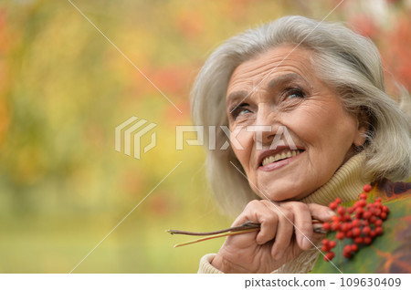 Happy senior woman in the autumn park Happy senior woman in the autumn park 109630409