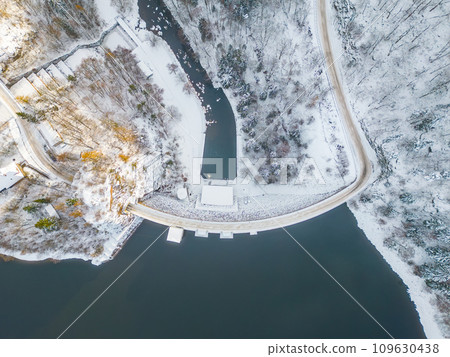 Sec water reservoir with concrete dam and wintertime snowy hills of Iron Mountains around. Czechia. Aerial view from drone. 109630438