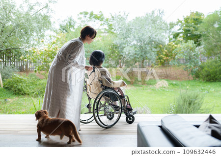 A mother in a wheelchair and her daughter in her thirties A mother in a wheelchair and her daughter in her thirties 109632446