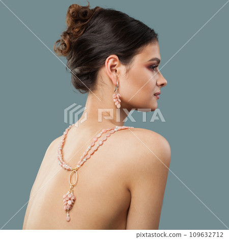 Perfect stylish brunette woman jewelry model with long curly hair, healthy skin and earring 109632712