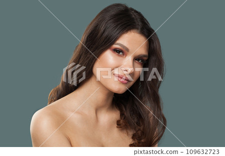 Perfect healthy fenale model with clear fresh skin. Brunette woman with dark hair on blue background Perfect healthy fenale model with clear fresh skin. Brunette woman with dark hair on blue background 109632723