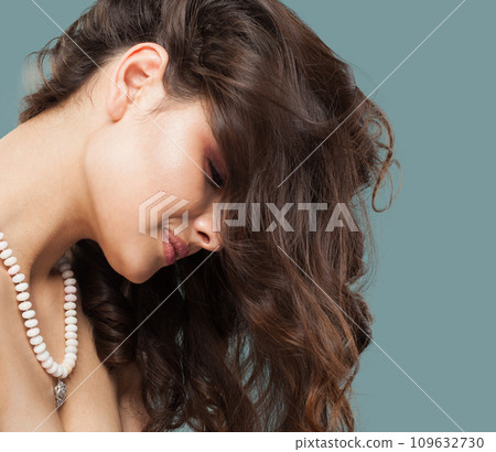 Cheerful stylish brunette woman jewelry model with long curly hair, healthy skin  109632730