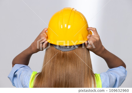 Female worker blonde hair lost her fingers from injured accident in industrial job. Woman engineer wear yellow hard hat show her lost fingers from work and insurance. White background isolated Female worker blonde hair lost her fingers from injured accident in industrial job. Woman engineer wear yellow hard hat show her lost fingers from work and insurance. White background isolated 109632960