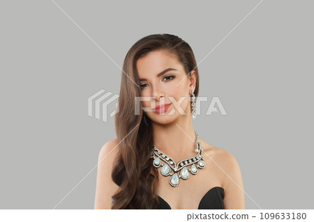 Glamorous jewelry woman brunette fashion model with gold diamond earning and luxury necklace posing Glamorous jewelry woman brunette fashion model with gold diamond earning and luxury necklace posing 109633180