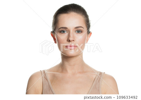 Young adult female model with healthy fresh wet skin and dark hair looking at camera Young adult female model with healthy fresh wet skin and dark hair looking at camera 109633492