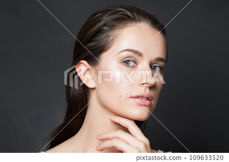 Cute woman touching her flawless glowy fresh clean facial skin, portrait. Healthcare, wellness Cute woman touching her flawless glowy fresh clean facial skin, portrait. Healthcare, wellness 109633520